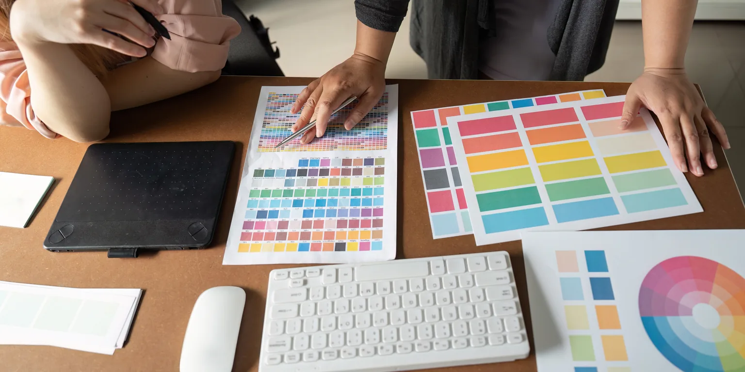 A design team chooses color palettes and swatches for a new dispensary brand identity